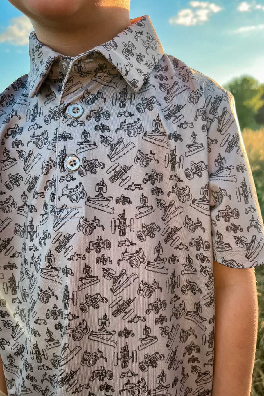 close up of boys polo print with antique tractors