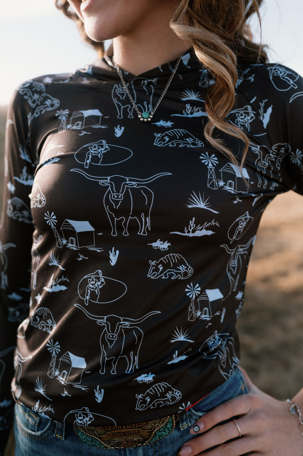 girl wearing it's about to get western performance hoodie in dark brown and light blue