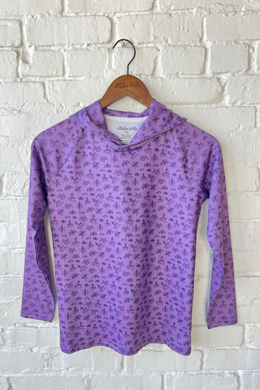 Youth performance hoodie in purple with small farm equipment icon print all over in dark purple.