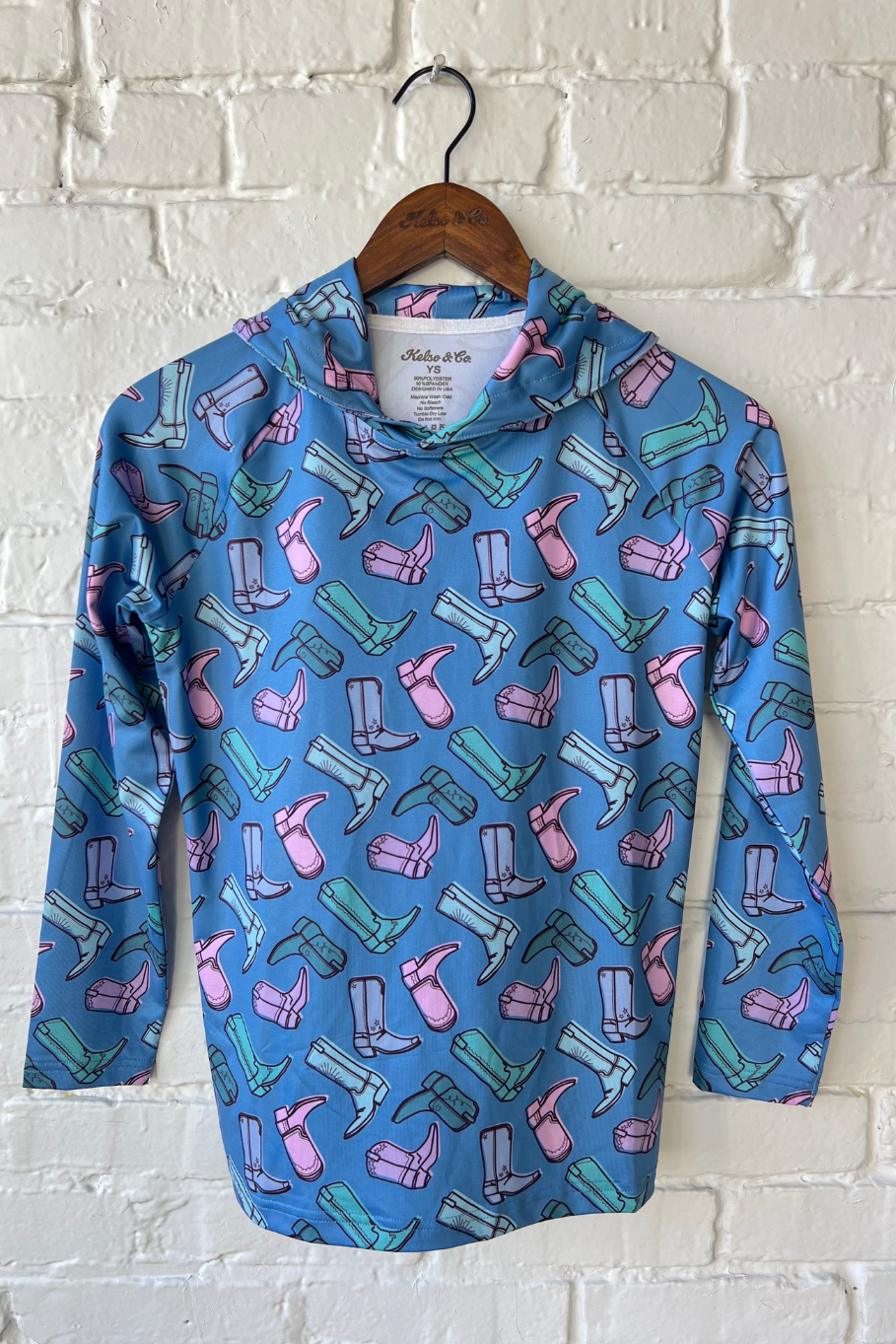 Youth lightweight performance hoodie in blue with pink, teal, and purple cowgirl boot pattern.