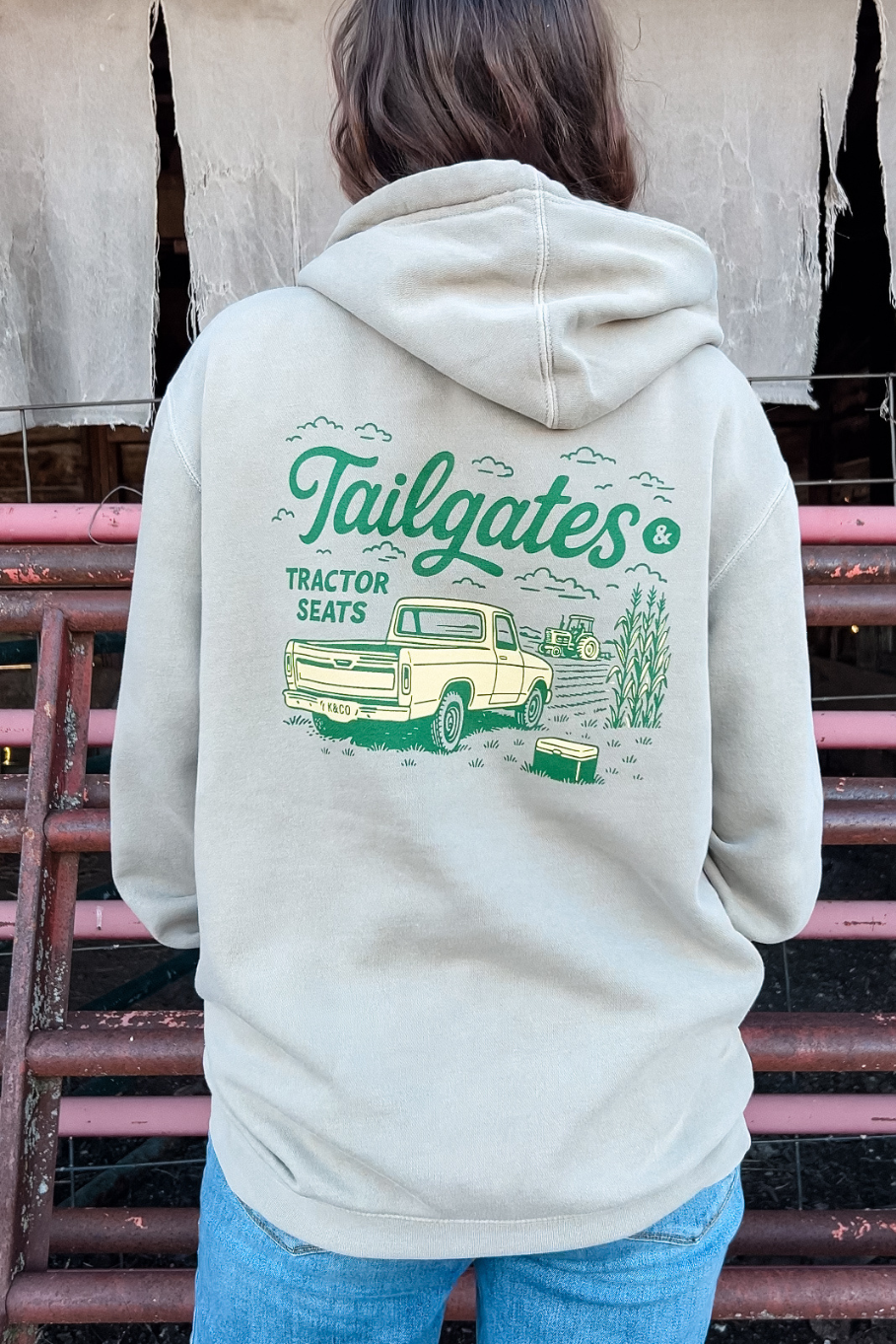 women standing in front of cattle panels with a hoodie on that says "tailgates & Tractor seats"