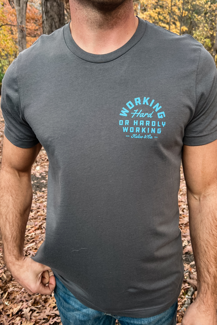 front of guy wearing working hard or hardly working asphalt graphic tee