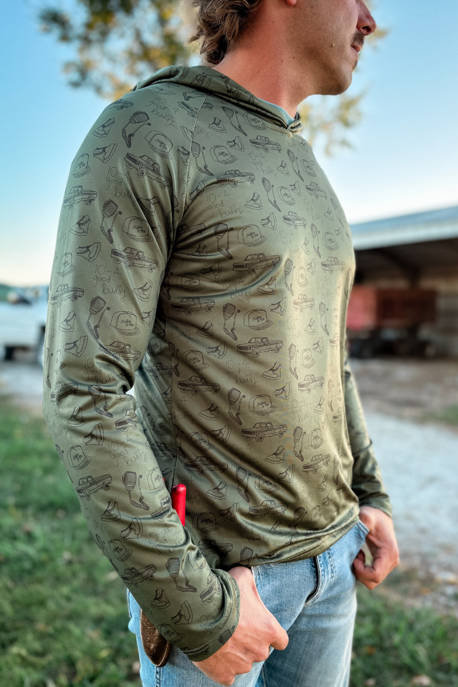 man standing on a farm with performance hoodie 10-4 good buddy