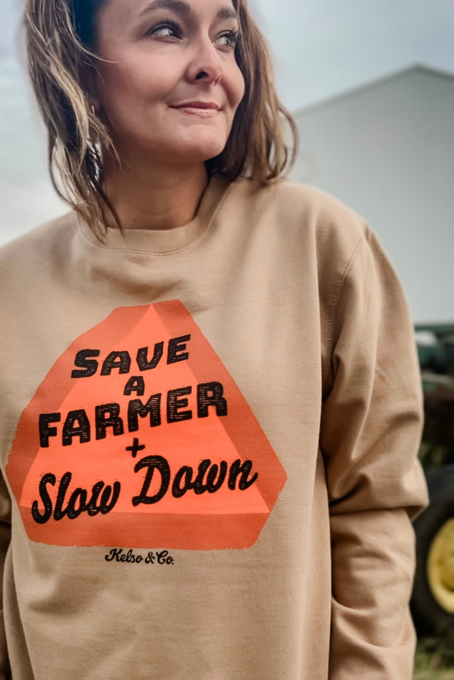 womens save a farmer and slow down graphic sweatshirt with a slow moving vehicle sign on the front