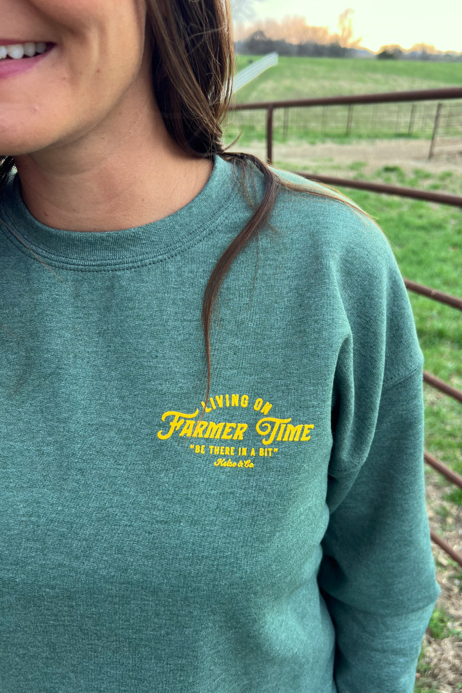 Green unisex sweatshirt with yellow lettering. 