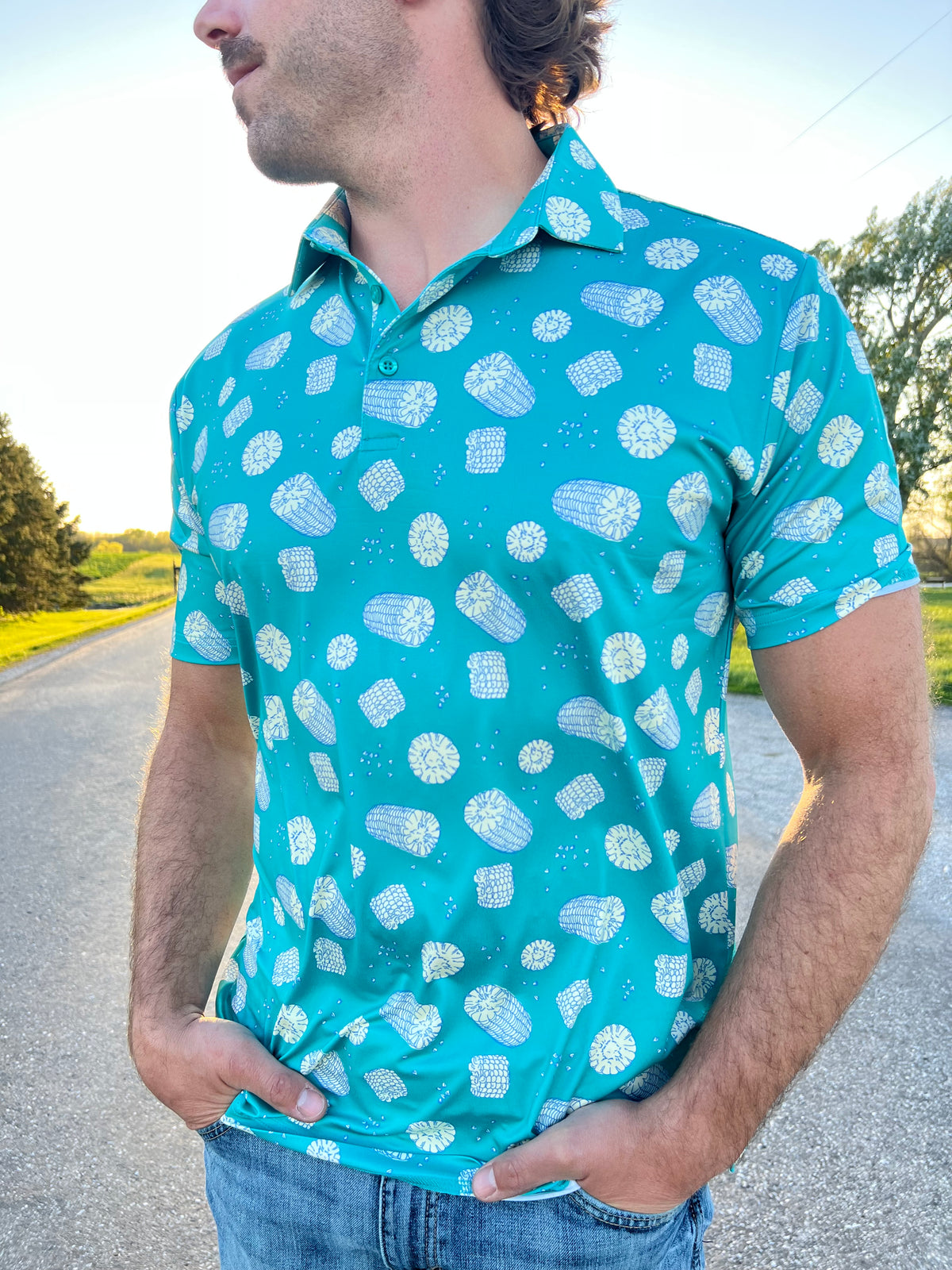 Man wearing sea green polo with corn print