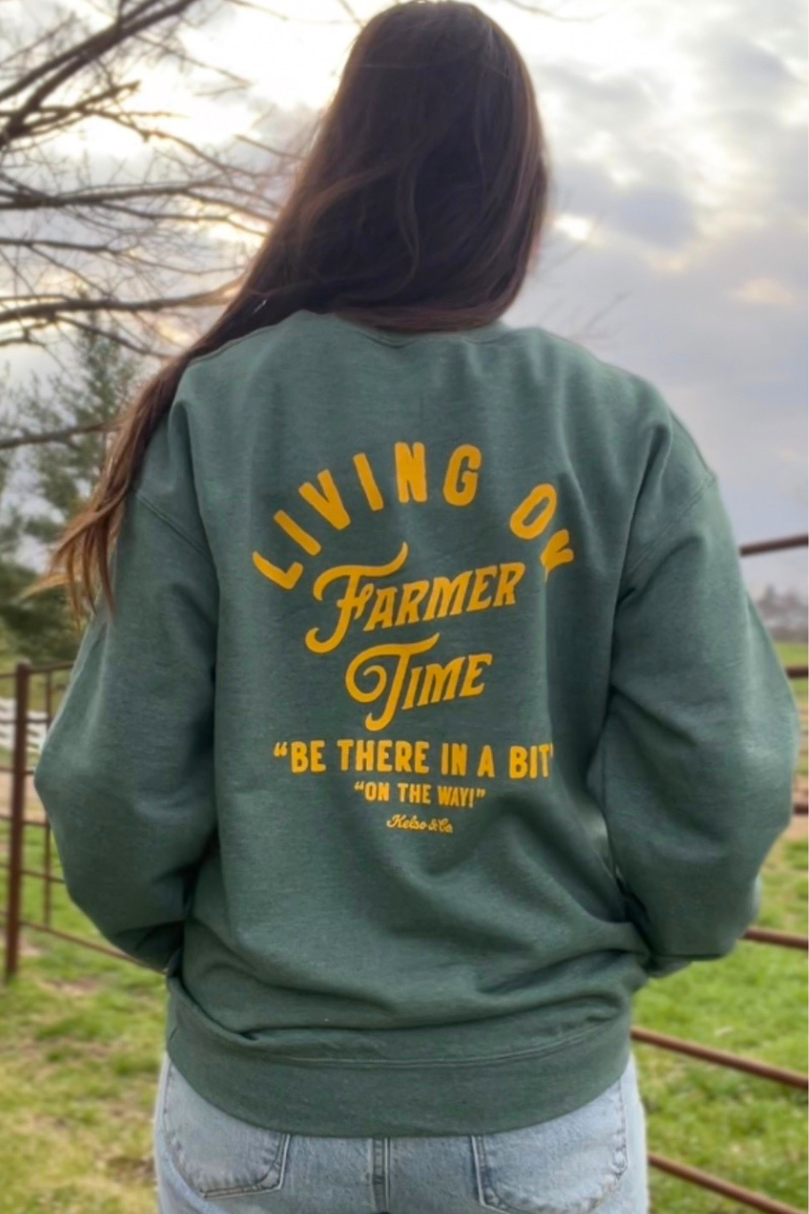 Green unisex sweatshirt with yellow lettering. 