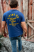 guy standing in front of a barn wearing a graphic tshirt that says "Living on Farmer Time"