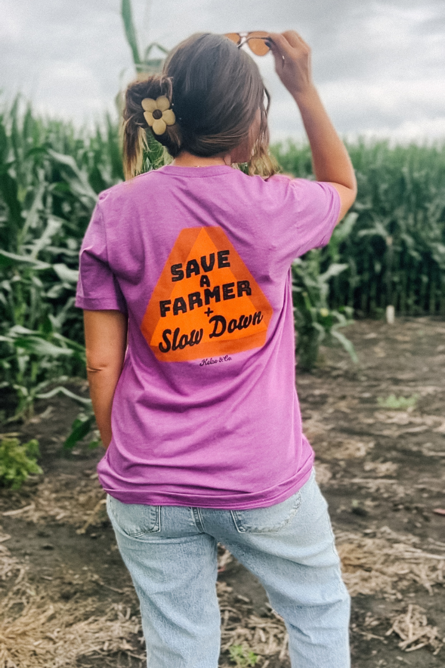 Save a Farmer and Slow Down in Magenta tshirt with slow moving vehicle sign