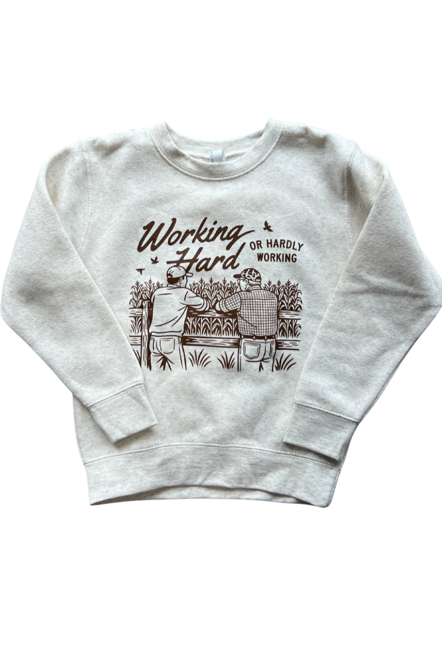 graphic crewneck with brown "working hard or hardly working" on oatmeal heather. 2 farmers overlooking a corn field