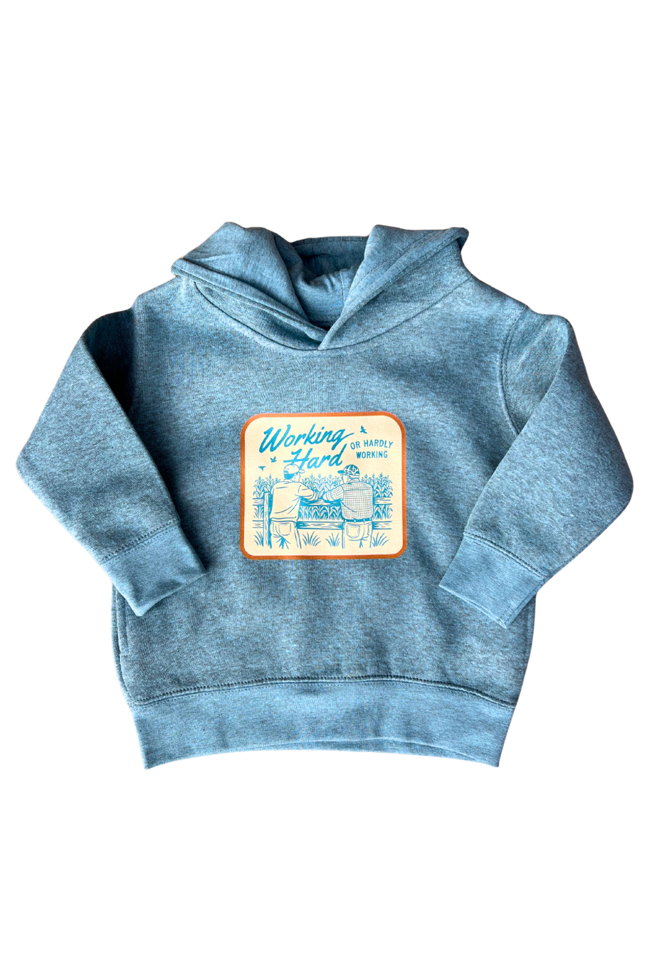Blue toddler farm hoodie with vintage farmer graphic and the phrase “working hard or hardly working,” laid flat for product display