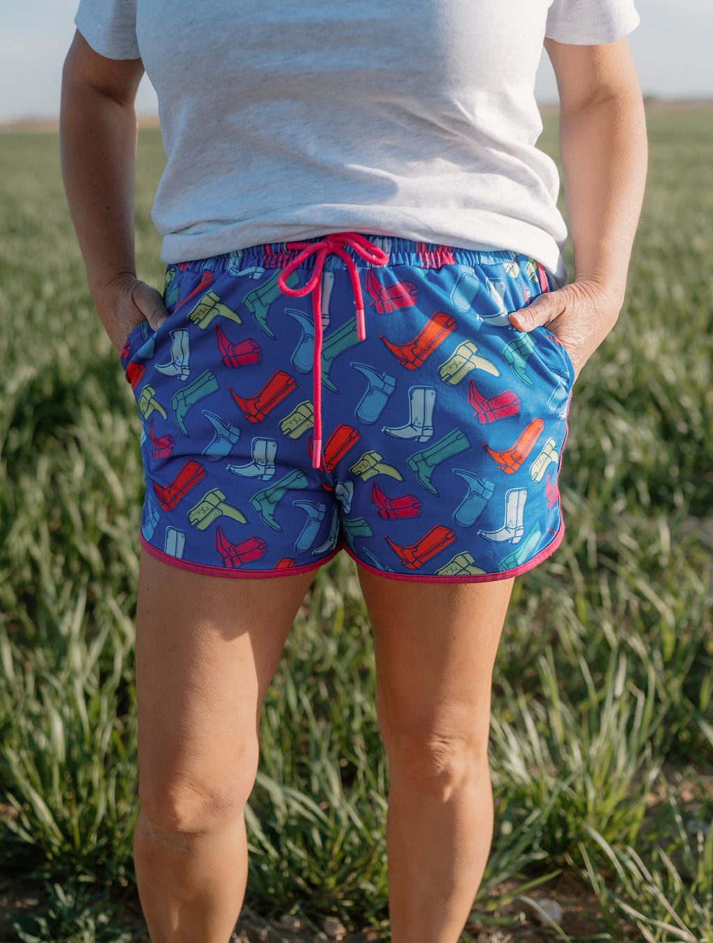women wearing neon cowgirl boot shorts with a royal blue base