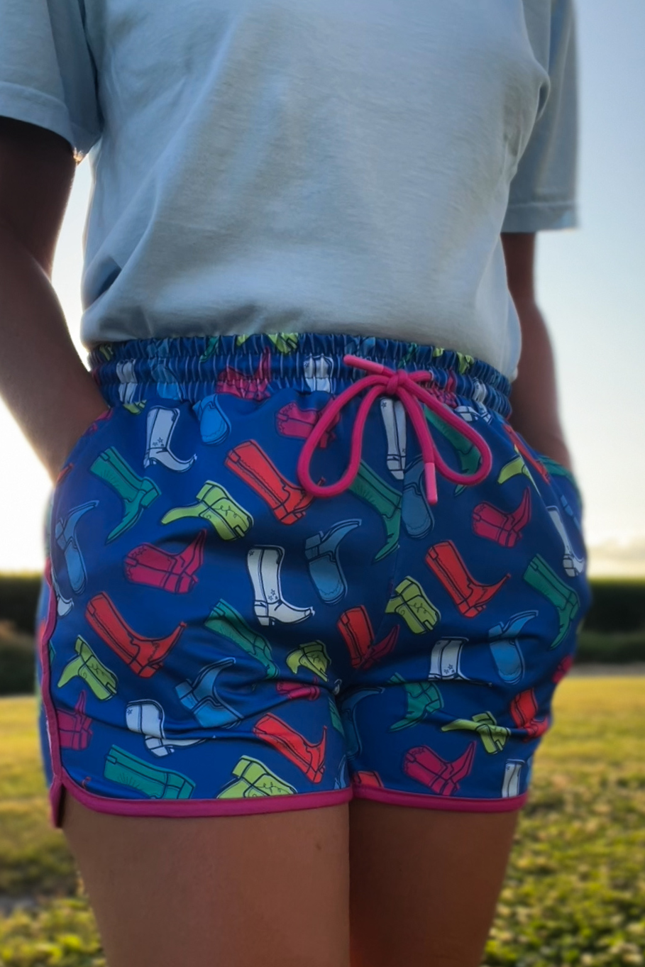 bright blue with neon colored cowgirl boots in a retro style women&#39;s short featuring pockets and an elastic waist band