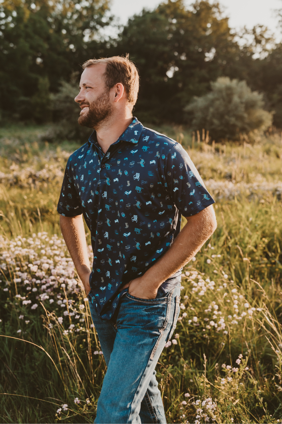pattern of vintage lawn chairs, coolers, ice and a lager on a men's performance polo in dark blue