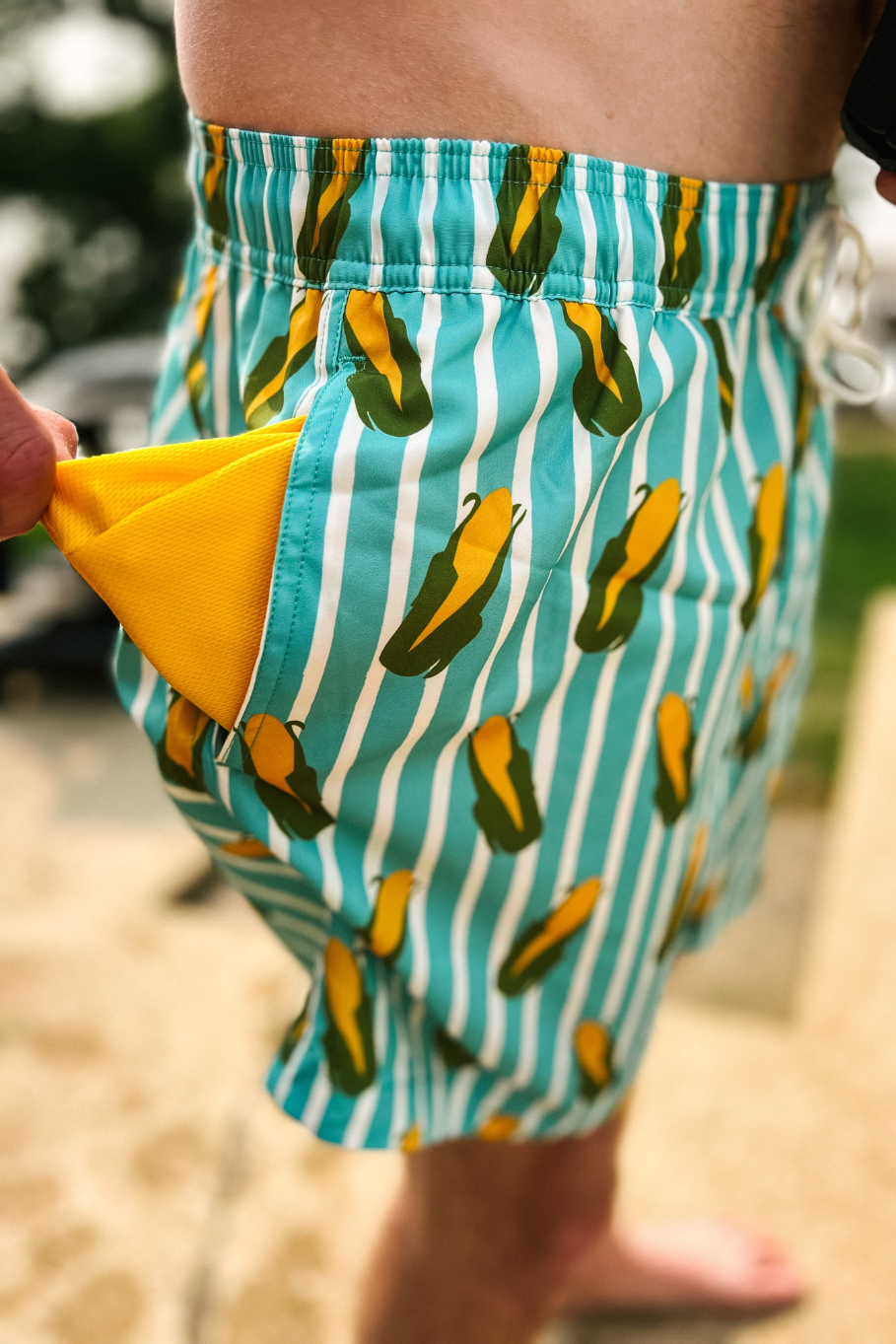 blue and white striped corn swim trunks with yellow pockets