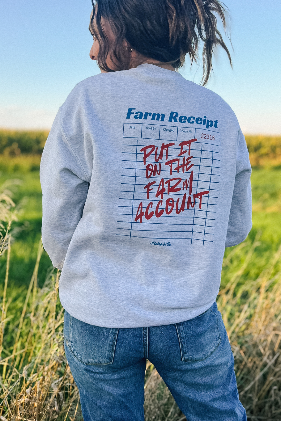 Graphic crewneck of a farm receipt on the back with "put it on the farm account"