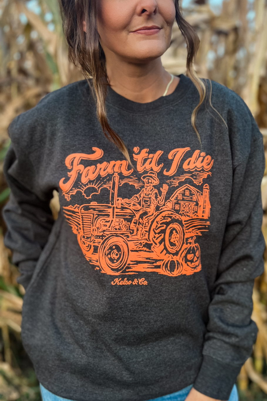 sweatshirt with a skeleton driving a tractor on a farm 