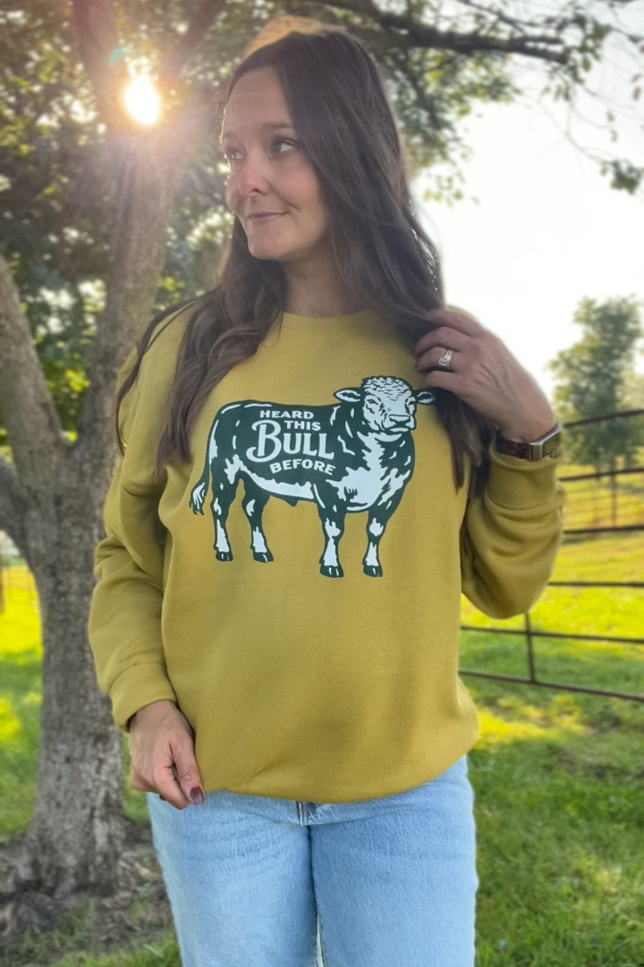 antique gold sweatshirt with green and gold hereford bull that says "heard this bull before"
