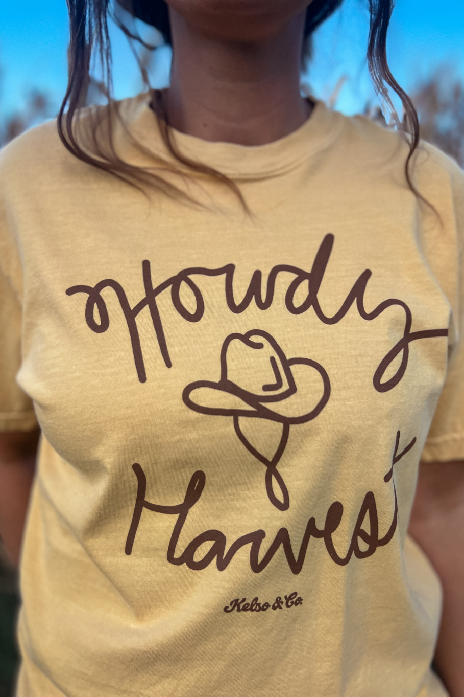 handdrawn graphic tee with a cowboy hat and "howdy harvest"