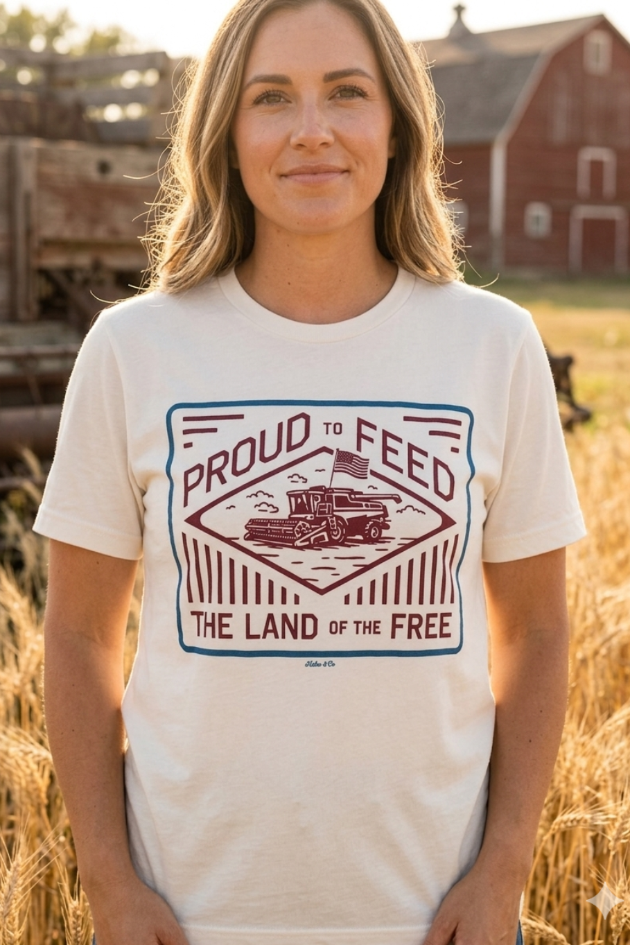 girl standing on a farm with a cream colored shirt that has a graphic on the front with a combine and an American flag that says proud to feed the land of the free