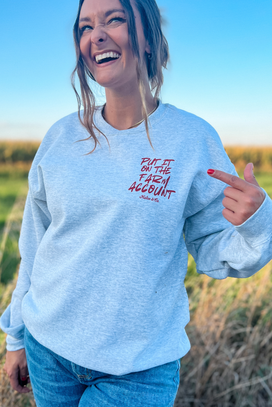 front of the farm account crewneck has a left crest print that says "put it on the farm account"