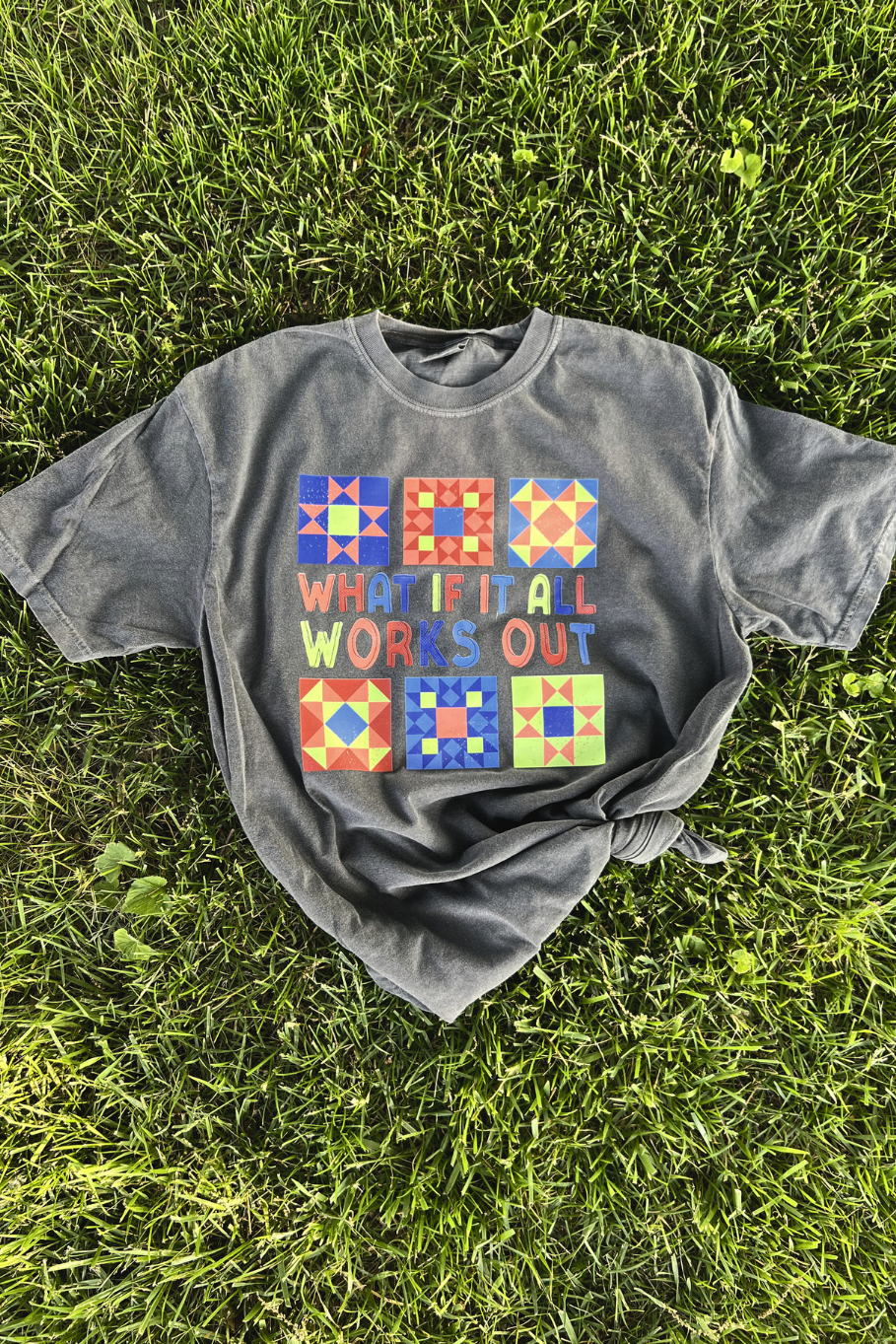 comfort colors pepper tee flatlay with multi colored barn quilt design that says "what if it all works out"