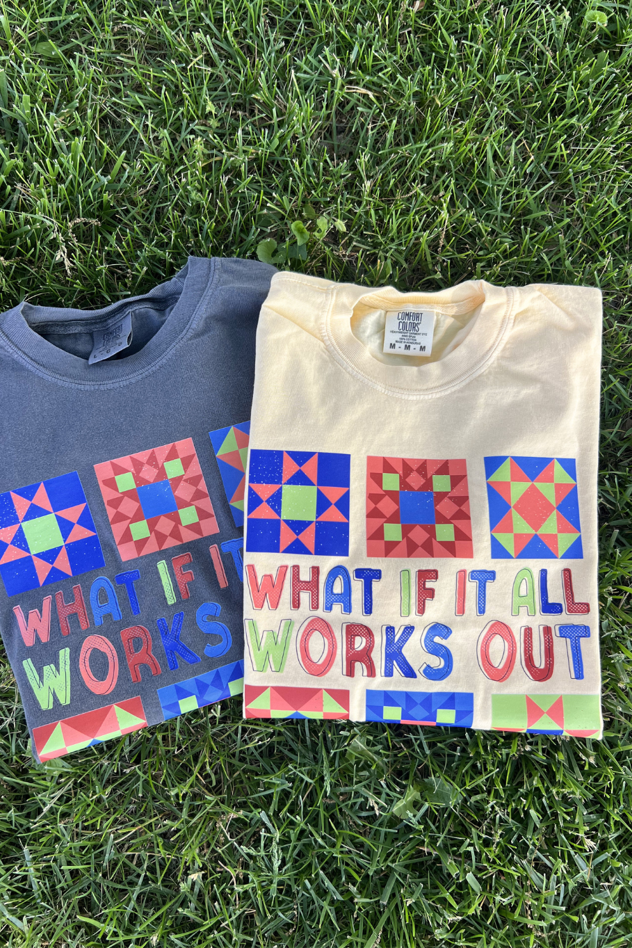 flat lay of two t-shirts: comfort colors pepper and comfort colors butter yellow, both in the design "what if it both works out" featuring multi-colored barn quilts