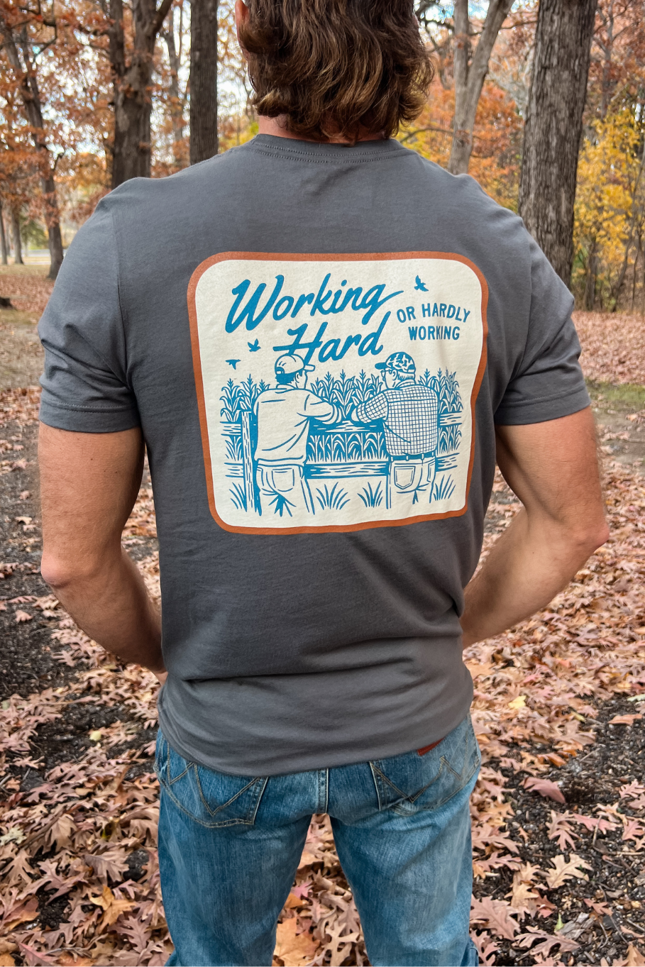 front of guy wearing asphalt graphic tee working hard or hardly working